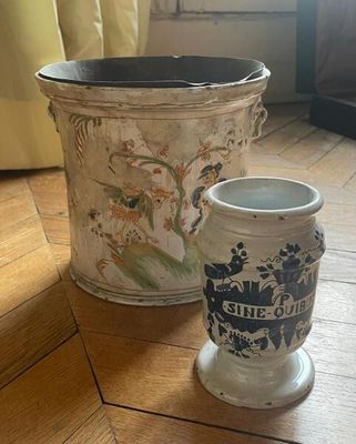 two vases sitting on the floor next to each other