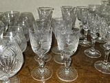 a lot of wine glasses sitting on a wooden table