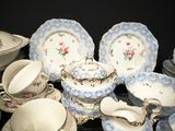 a lot of china dishes and cups on the table