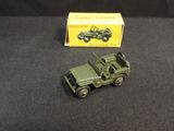 a toy army vehicle and a box on a table