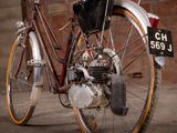 a bike that is parked in front of a brick wall