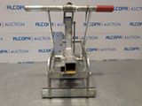 a close up of a machine on a table with a sign in the background