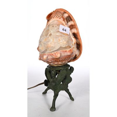 a statue of a man holding a shell on top of his head