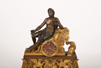 a statue of a man sitting on top of a clock