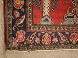a rug on the floor with a vase on it