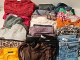 many different types of clothes laid out on a table