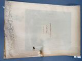 an old book with a piece of paper on top of it