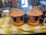 two clay lanterns sitting on a table in a workshop