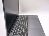 a silver laptop with a black keyboard on a white surface