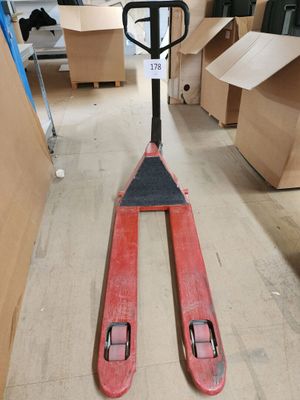a forklift that is sitting on the floor in a warehouse