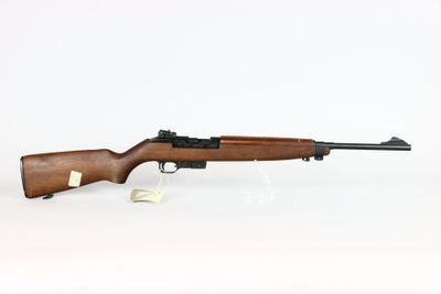 a rifle on a white surface with a white background