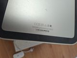 a laptop computer sitting on top of a wooden table