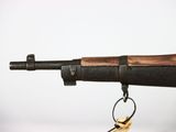 a rifle that is attached to a keychain on a table