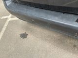 a black car with a hole in the front of it