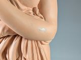 a statue of a woman holding a cell phone to her ear