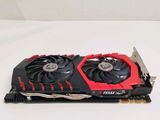 a close up of a red and black graphics card on a white surface