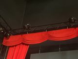 a stage with a red curtain and lights on it