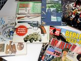 a lot of books and magazines on a table