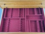 a wooden box that has a bunch of compartments inside of it