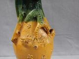 a yellow and green vase sitting on a table
