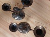 three silver vases sitting on a wooden table
