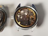 two watches sitting next to each other on a table