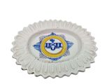 a white plate with a blue and yellow emblem on it