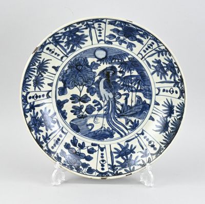blue and white plate with a bird and flowers on it