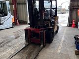 a forklift truck that is parked in a warehouse