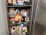 a refrigerator that has a lot of food inside of it
