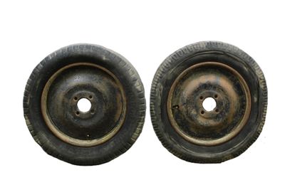 pair of old wheels on a white background with a hole in the center