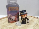 a small figurine of a man in a top hat next to a box