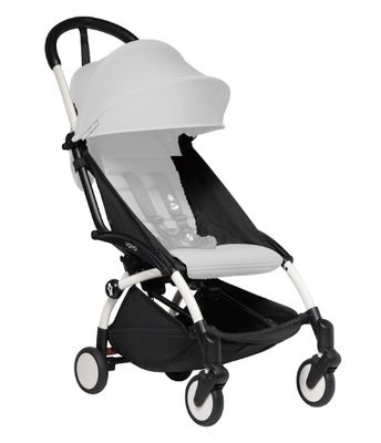 the buggy stroller is white and black with a white seat
