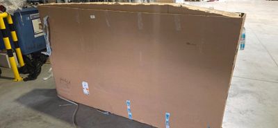 a large cardboard box sitting on a pallet in a warehouse