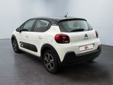 the rear of a white citrole parked in a room