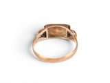 a close up of a gold ring with a stone in the middle