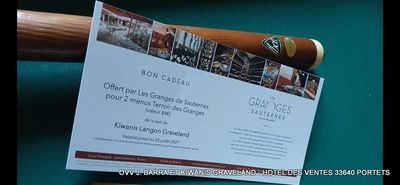 une photo montrant une batte de baseball et un billet posés sur une table