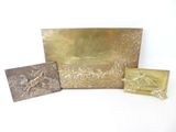 three different types of brass plaques on a white surface