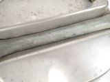two metal pans sitting on top of a white counter