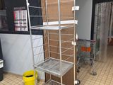 a metal shelf that has boxes on it in a store