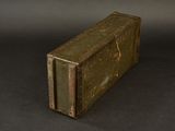 an old green suitcase sitting on a black surface