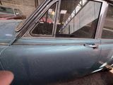 a blue car that is parked in a garage