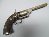 a close up of a gun on a table with a white background