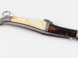 a small knife with a wooden handle on a white surface