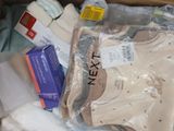 a box full of baby clothes and other items in it