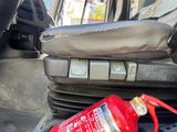 a red fire extinguisor sitting on the seat of a car