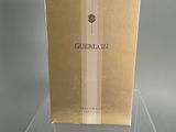clear acrylic display case for a perfume bottle on a grey surface