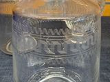 three clear glass vases sitting on a table
