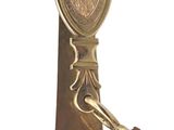 a gold tie bar with a shield on it