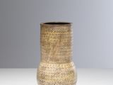 un vase marron posé sur une table blanche